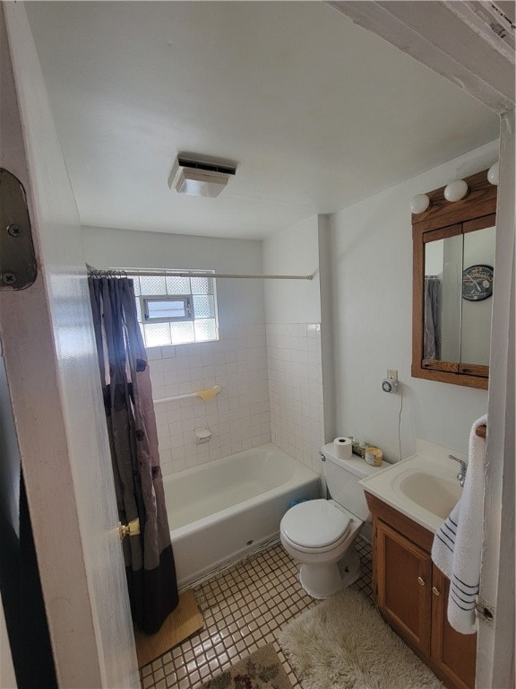 full bathroom featuring vanity, shower / bathtub combination with curtain, toilet, and tile patterned floors