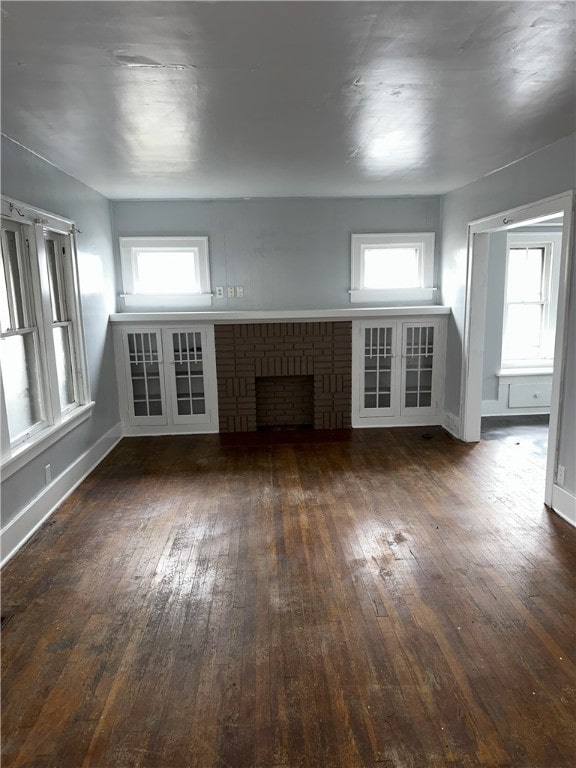 unfurnished living room featuring dark hardwood / wood-style floors and a fireplace