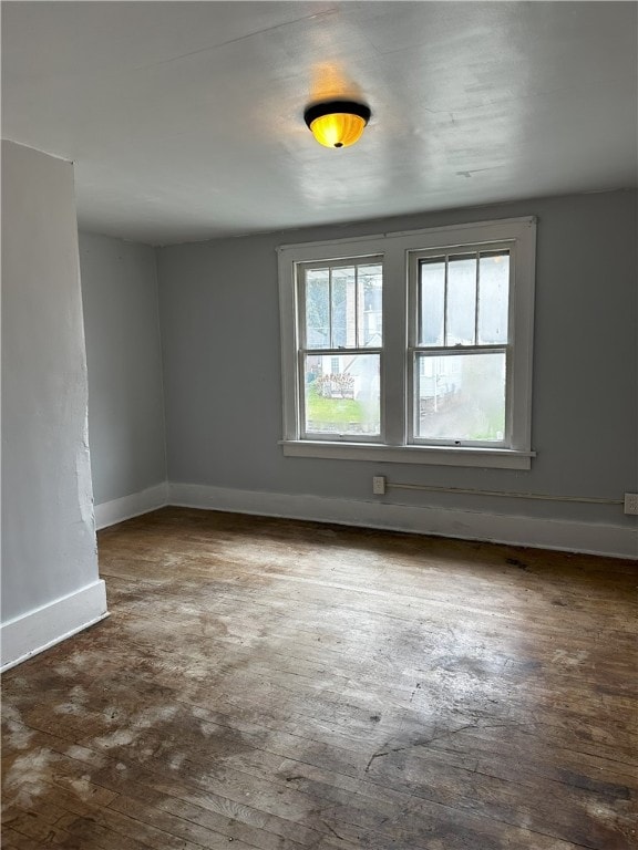 spare room with dark hardwood / wood-style floors