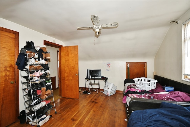 bedroom featuring hardwood / wood-style flooring, vaulted ceiling, and ceiling fan