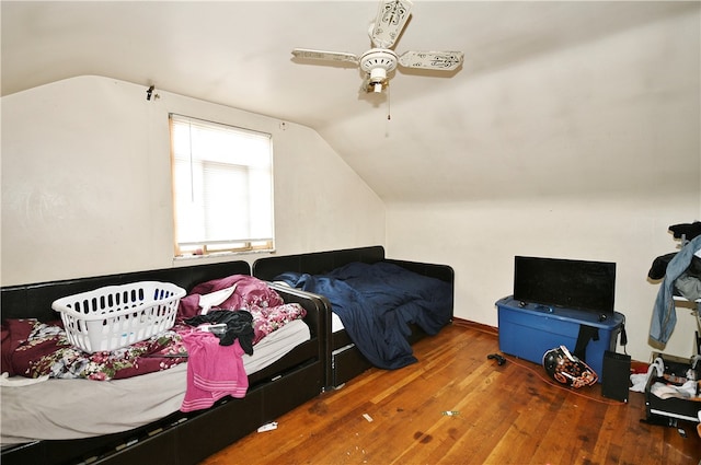 bedroom with hardwood / wood-style flooring, lofted ceiling, and ceiling fan