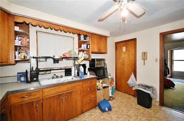 kitchen featuring sink, light tile patterned floors, and ceiling fan