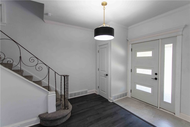 foyer entrance with dark hardwood / wood-style floors and crown molding