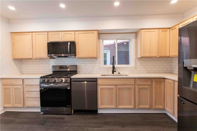 kitchen with dark hardwood / wood-style floors, stainless steel appliances, and backsplash