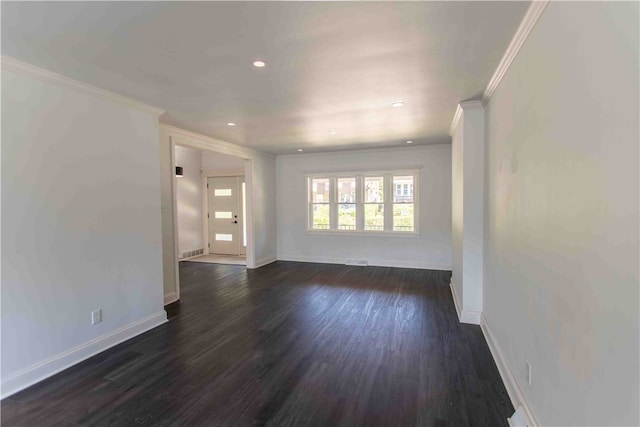 spare room featuring wood-type flooring and ornamental molding