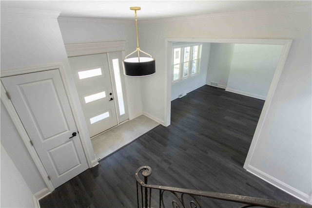 foyer with ornamental molding, lofted ceiling, and dark wood-type flooring