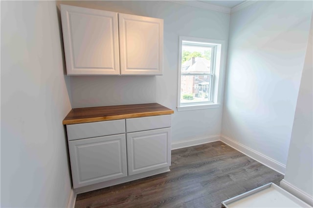 interior space featuring crown molding and dark hardwood / wood-style flooring