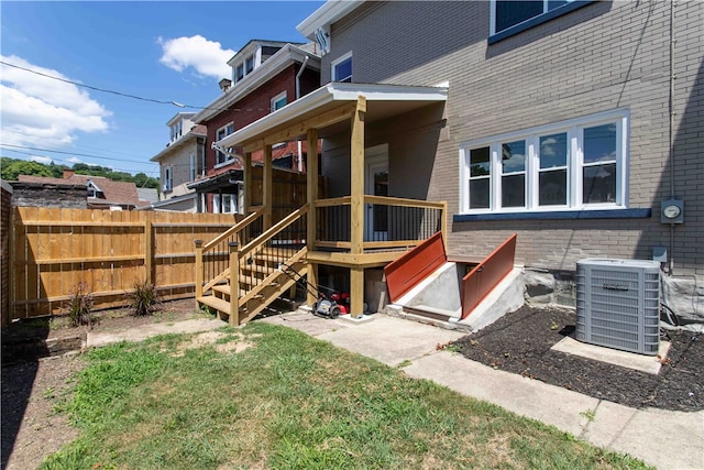 back of property featuring a wooden deck and central air condition unit