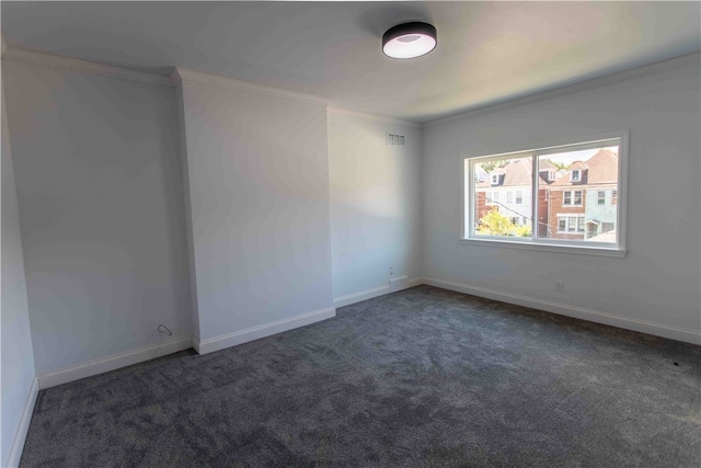 carpeted spare room featuring crown molding