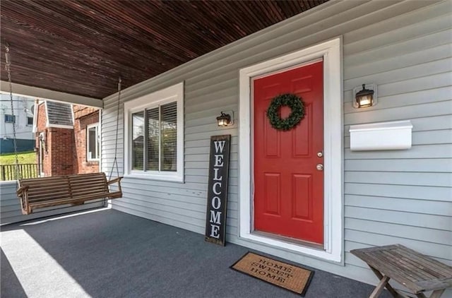 view of exterior entry with covered porch