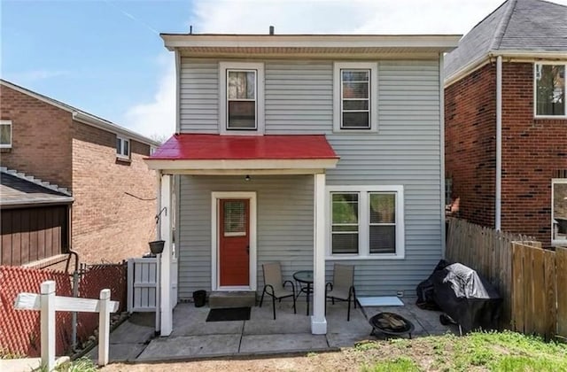 view of front of house with a fenced backyard and a patio