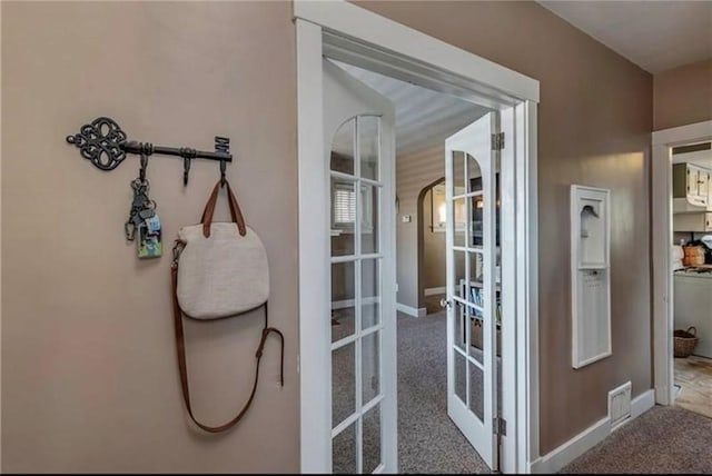 doorway to outside featuring french doors and carpet floors