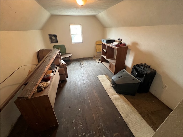 bonus room with vaulted ceiling and dark hardwood / wood-style floors