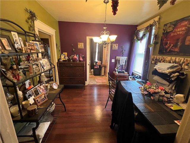 dining space with an inviting chandelier and dark wood-type flooring