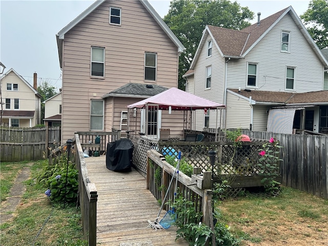 back of house featuring a gazebo and a deck