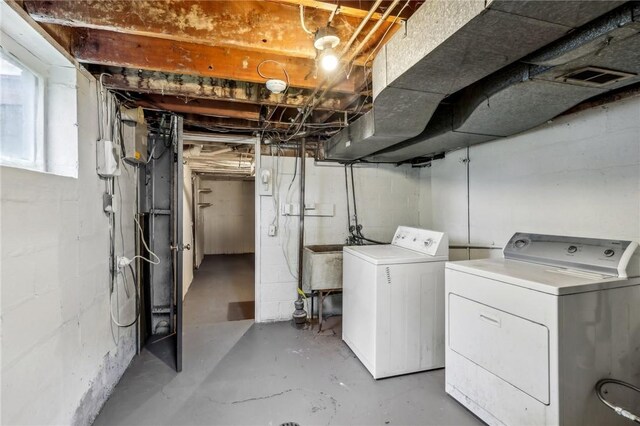 basement with sink and washing machine and clothes dryer