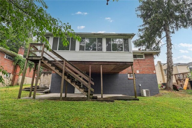 back of house with a patio, central AC, and a lawn