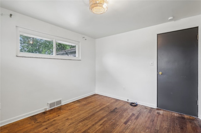 empty room with hardwood / wood-style flooring