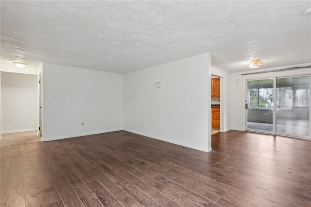 unfurnished room with a textured ceiling and hardwood / wood-style floors