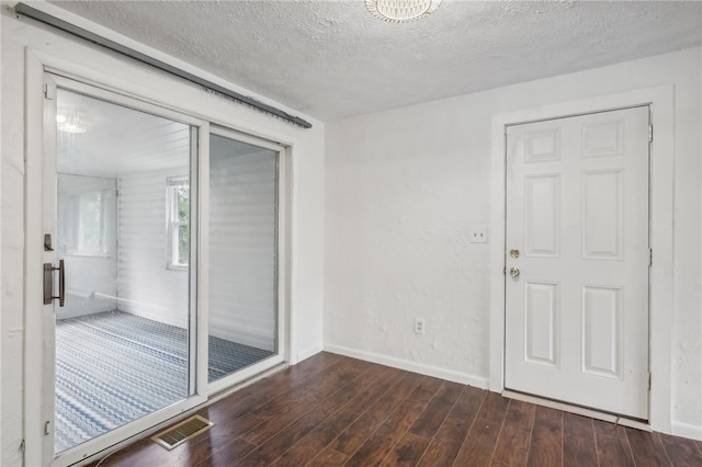 spare room featuring a textured ceiling and hardwood / wood-style flooring