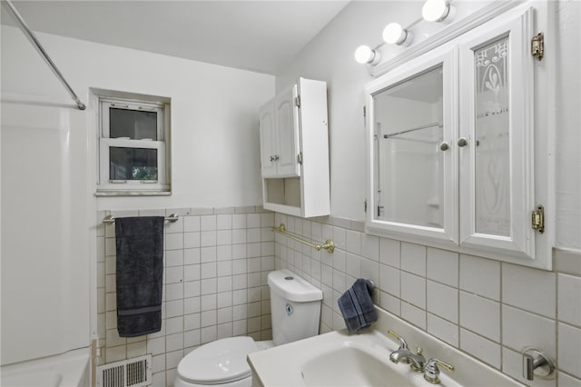 full bathroom with bathing tub / shower combination, sink, toilet, and tile walls