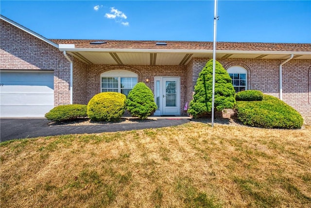 view of front of property featuring a garage and a front lawn