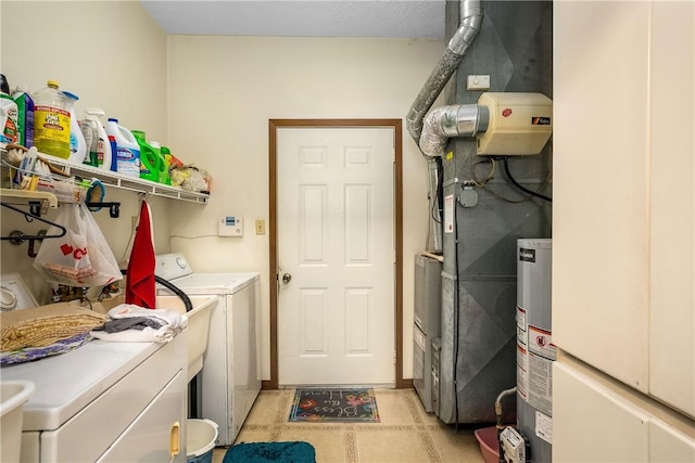 washroom featuring gas water heater and washing machine and clothes dryer