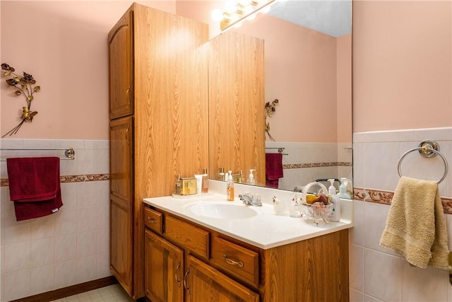 bathroom featuring vanity and tile walls