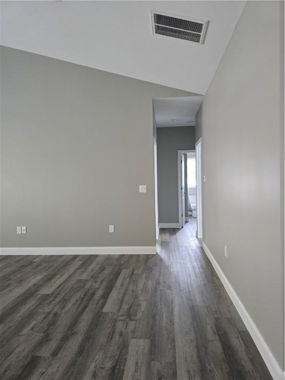 unfurnished room featuring dark hardwood / wood-style flooring