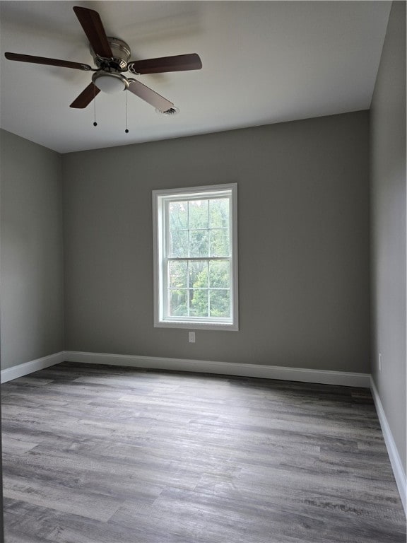 empty room with wood-type flooring and ceiling fan