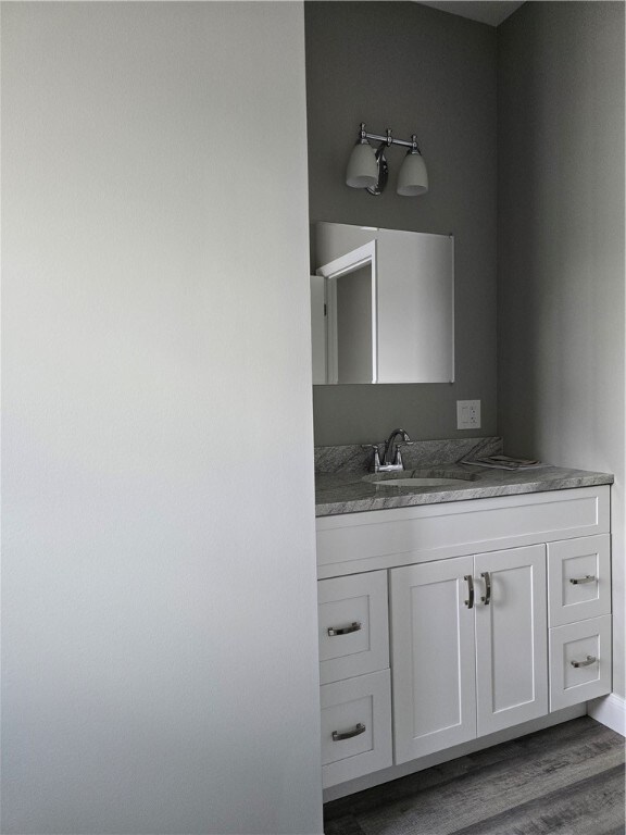 bathroom featuring vanity and hardwood / wood-style floors