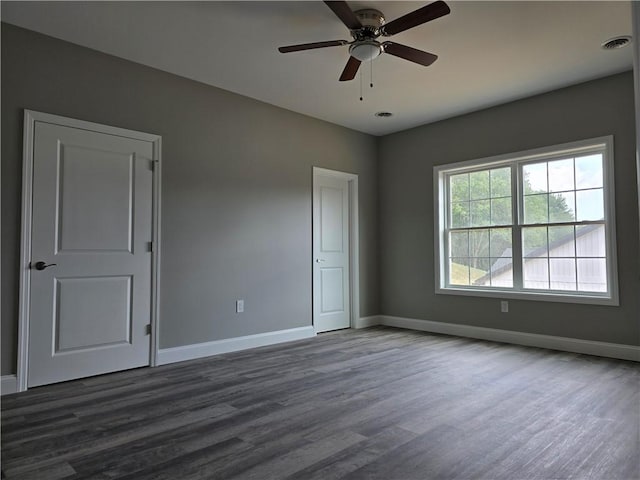 unfurnished room featuring dark hardwood / wood-style floors and ceiling fan