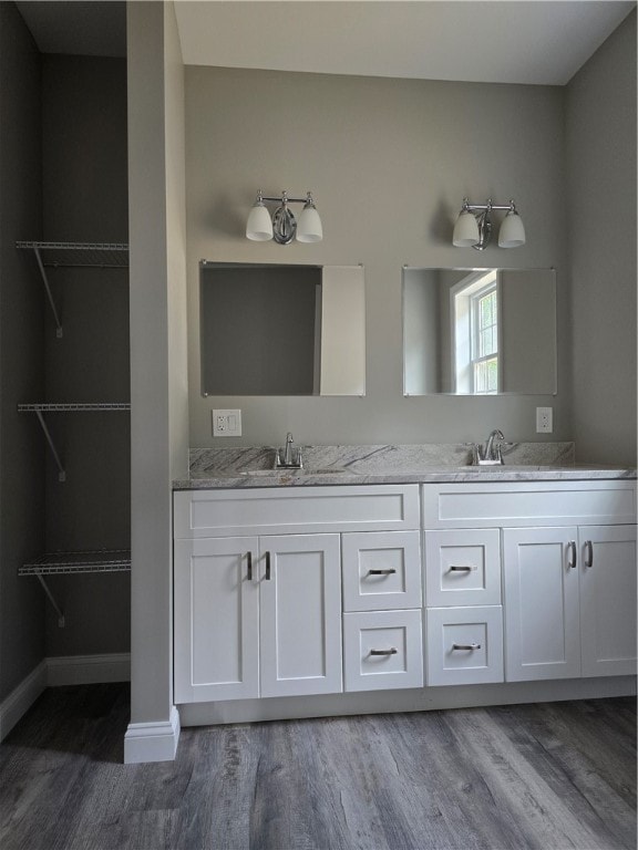 bathroom featuring hardwood / wood-style flooring and double sink vanity