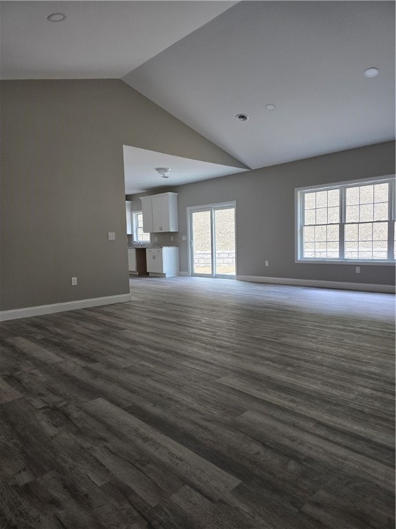 unfurnished living room with hardwood / wood-style flooring and high vaulted ceiling