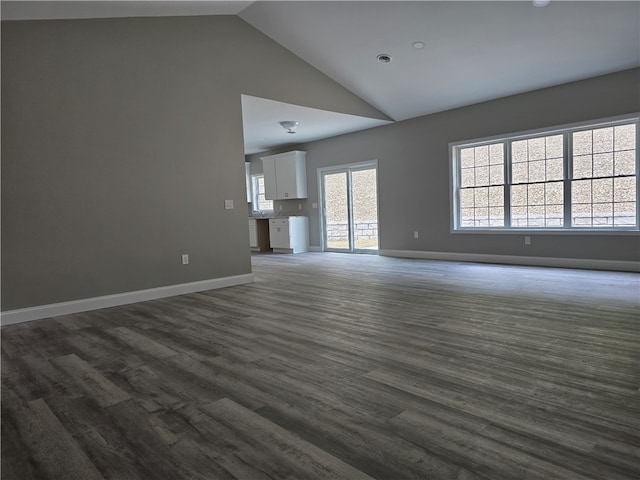 unfurnished living room featuring hardwood / wood-style floors and high vaulted ceiling