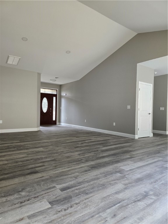 unfurnished living room with wood-type flooring and vaulted ceiling