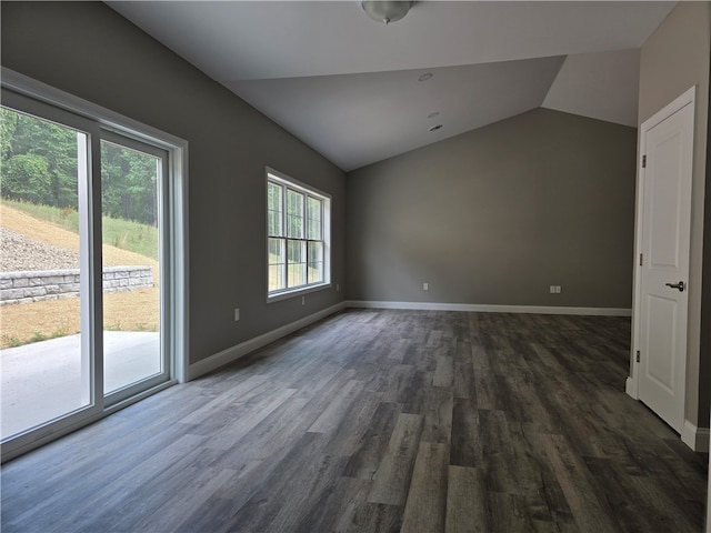 spare room with lofted ceiling and hardwood / wood-style floors