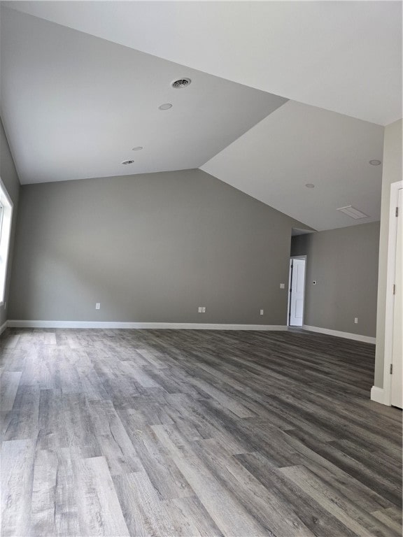 additional living space with wood-type flooring and lofted ceiling