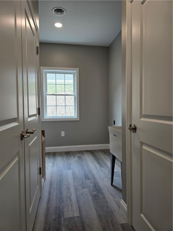 interior space with hookup for an electric dryer and dark wood-type flooring