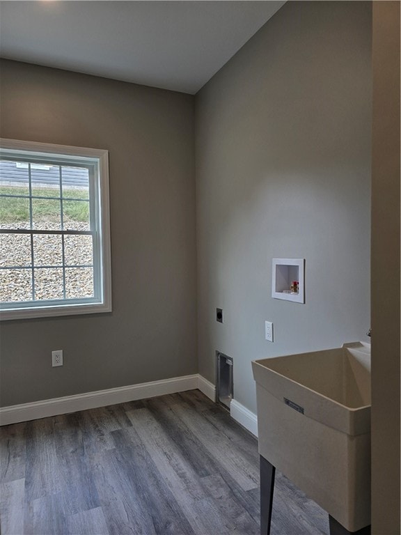 laundry area featuring hardwood / wood-style flooring, hookup for an electric dryer, sink, and washer hookup