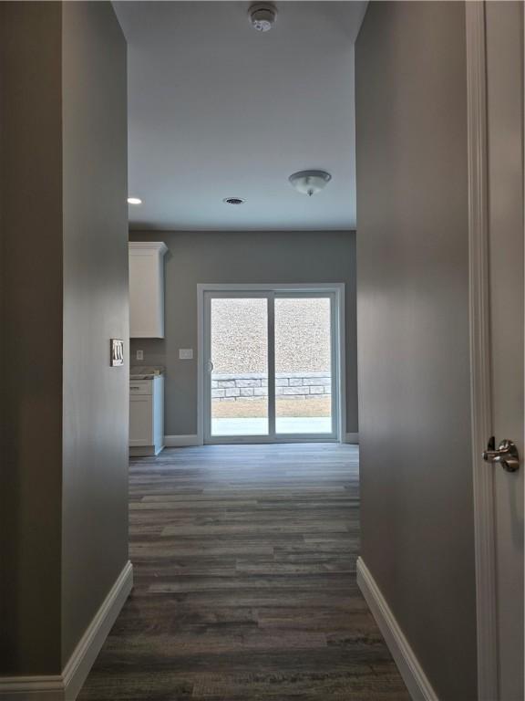 corridor with dark hardwood / wood-style floors