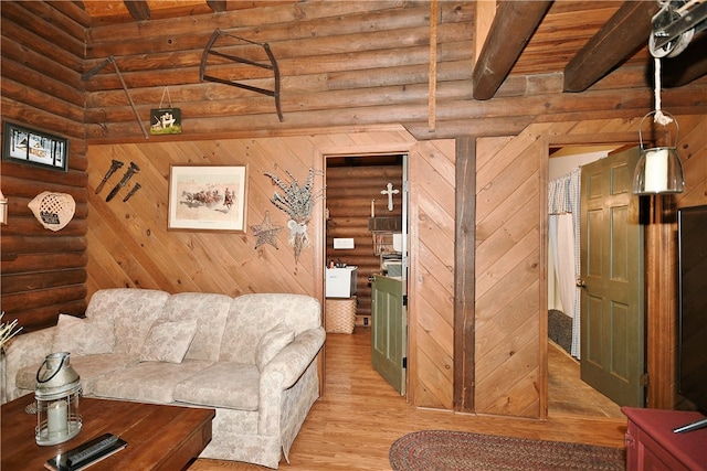 unfurnished living room with light wood-type flooring, beamed ceiling, log walls, and wooden ceiling