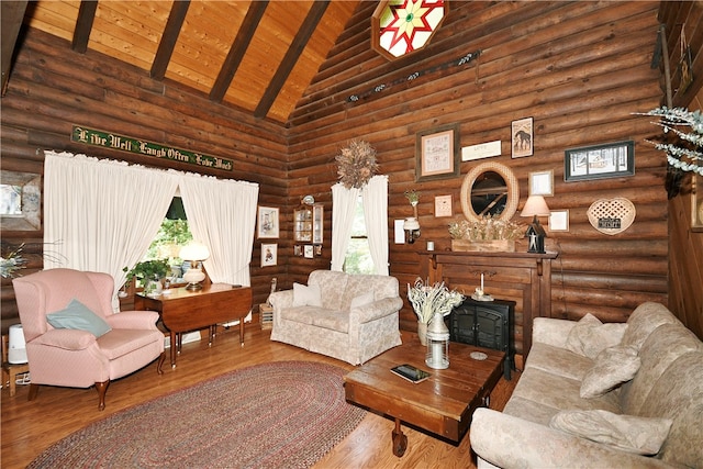 living room with wood ceiling, high vaulted ceiling, log walls, hardwood / wood-style flooring, and beamed ceiling