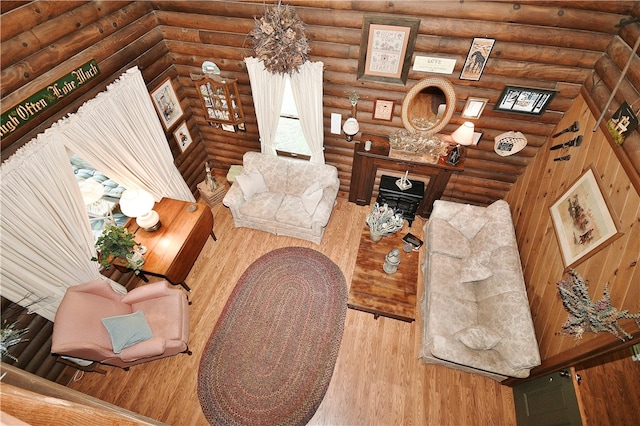 living room with hardwood / wood-style flooring and rustic walls