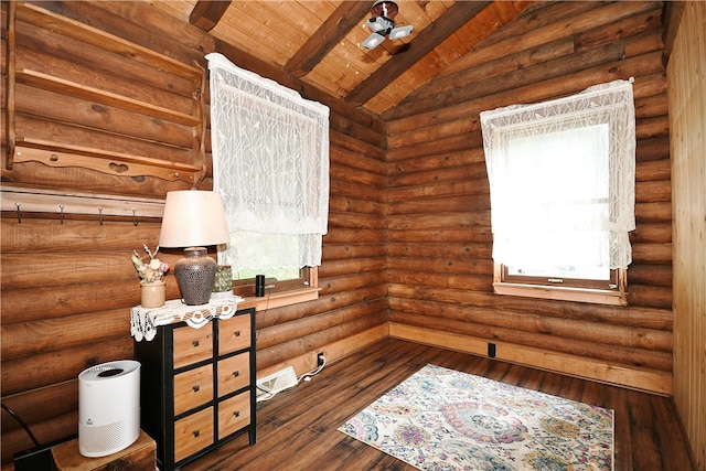 interior space with wood ceiling, plenty of natural light, rustic walls, and dark hardwood / wood-style floors