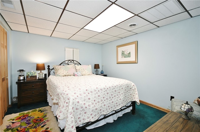 bedroom featuring hardwood / wood-style floors and a paneled ceiling