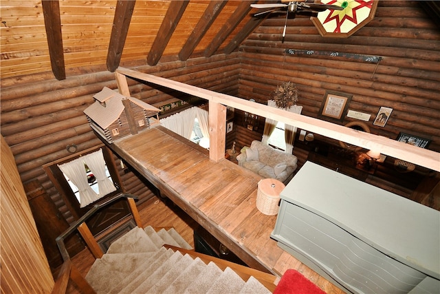 stairway featuring wood ceiling, rustic walls, and lofted ceiling with beams