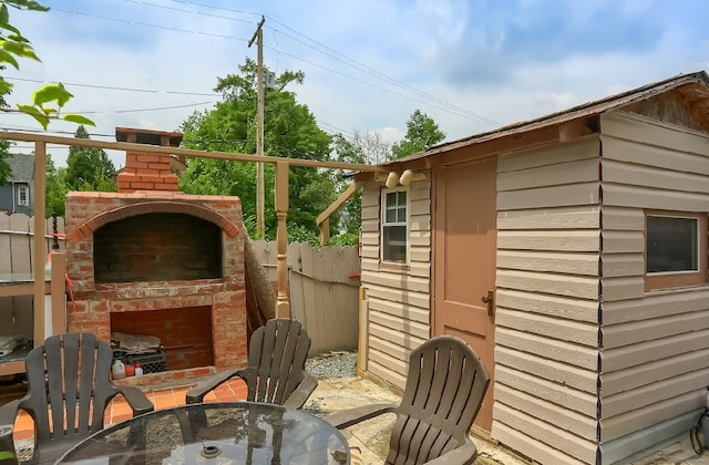 view of outbuilding with an outdoor fireplace