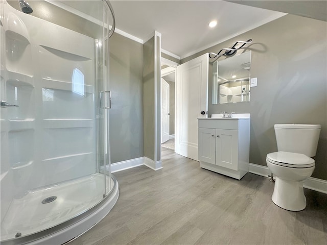 bathroom with a shower with door, vanity, hardwood / wood-style flooring, and toilet