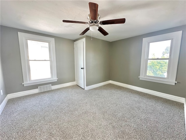 carpeted empty room with ceiling fan